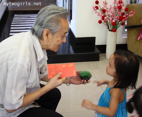 Zaria serving tea to Ah Kong